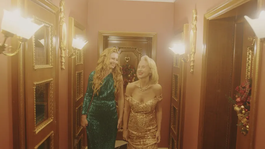 Two guests in evening gowns arriving at a gala