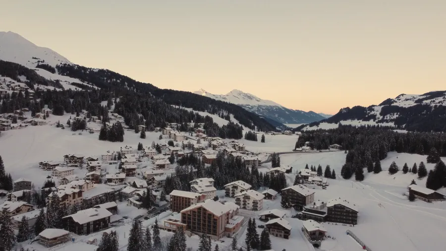 A snow-covered Alpine village at sunset