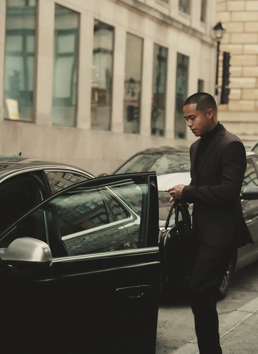 A close protection officer opening a car door